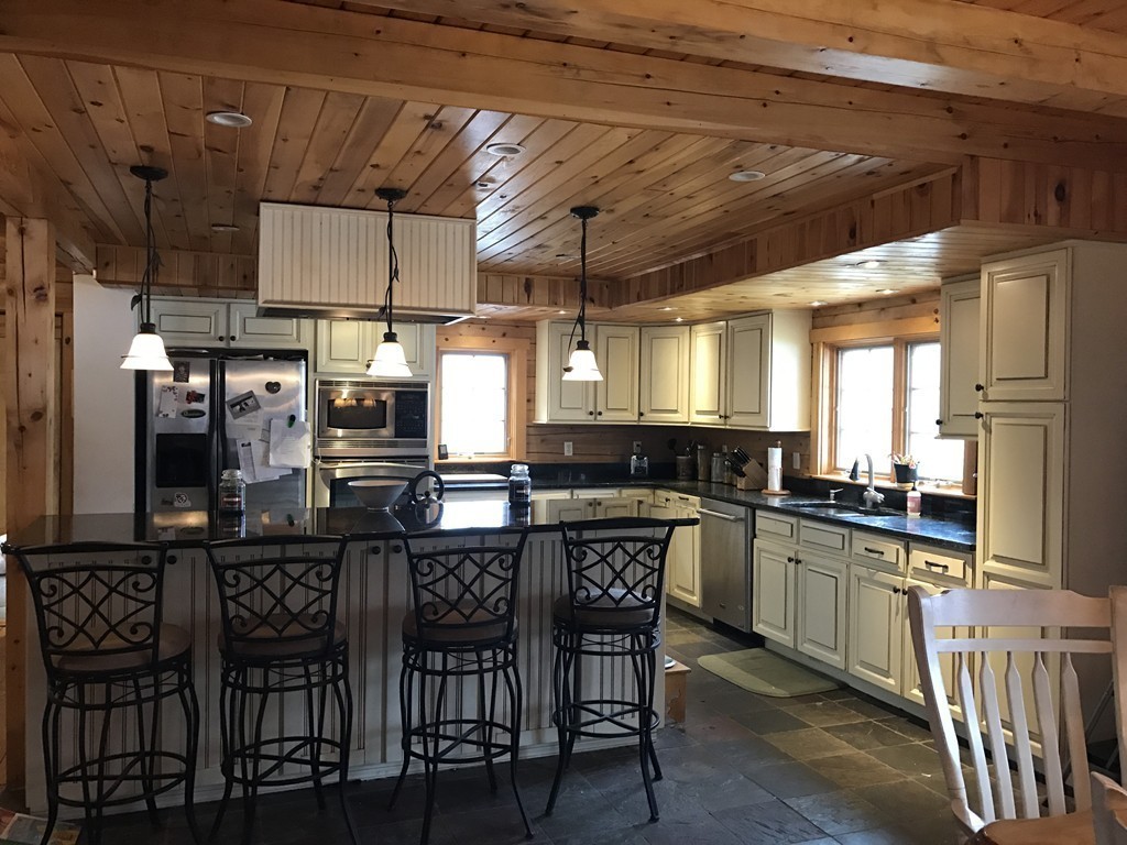 944 George Hill Road Lancaster, MA 01523 - Photo 3 of 22 a kitchen with a table and chairs in it