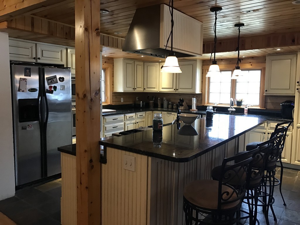 944 George Hill Road Lancaster, MA 01523 - Photo 4 of 22 a kitchen with center island table and chairs