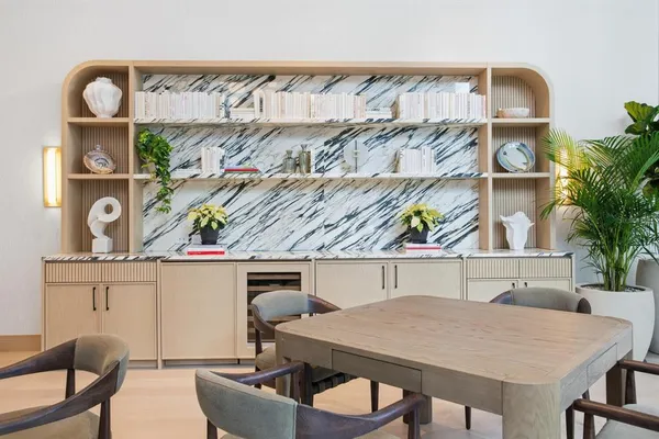 a view of a kitchen with furniture and wooden floor