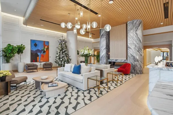 a living room with furniture and a chandelier