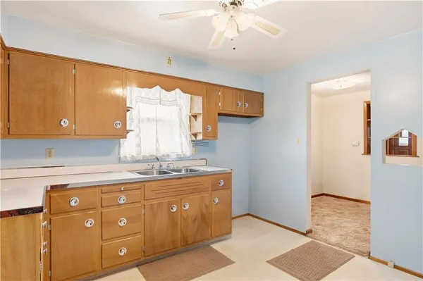 a kitchen with a sink cabinets and appliances