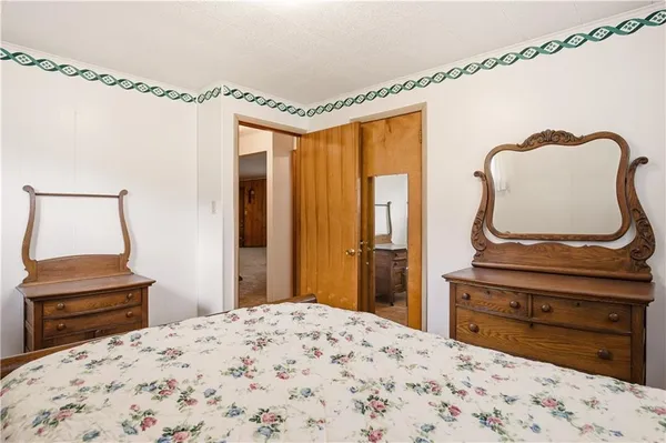 a bedroom with a bed and a dresser