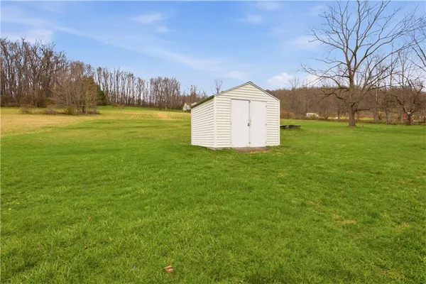 a view of a field with a house in the background