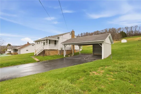 a view of a house with a yard and pathway