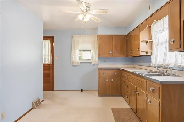 a kitchen with cabinets appliances and a window