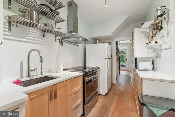 a kitchen with stainless steel appliances granite countertop a sink and a stove