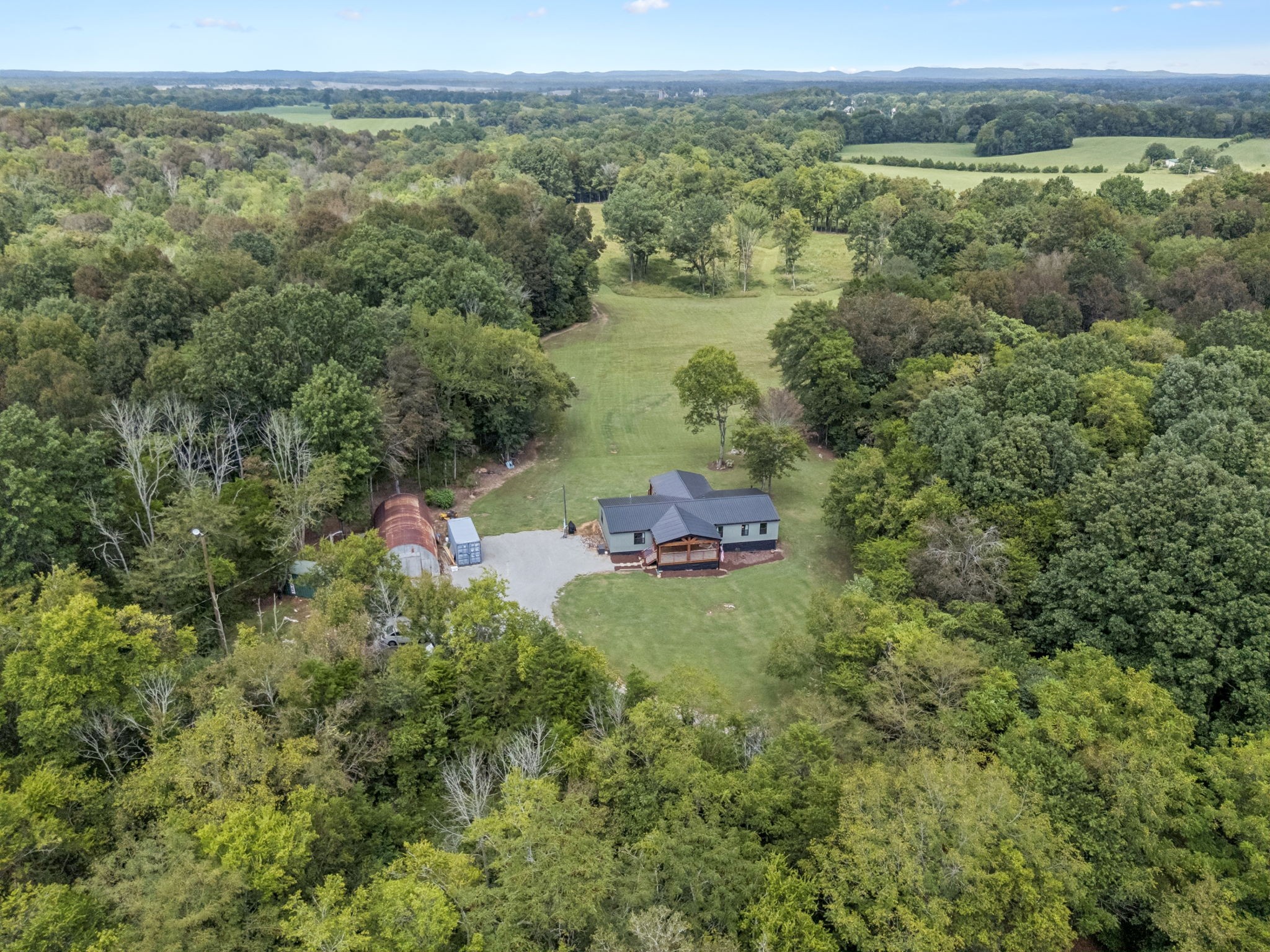 3680 Clark Road Lewisburg, TN 37091 - Photo 12 of 37 a view of a lush green forest with houses and city view