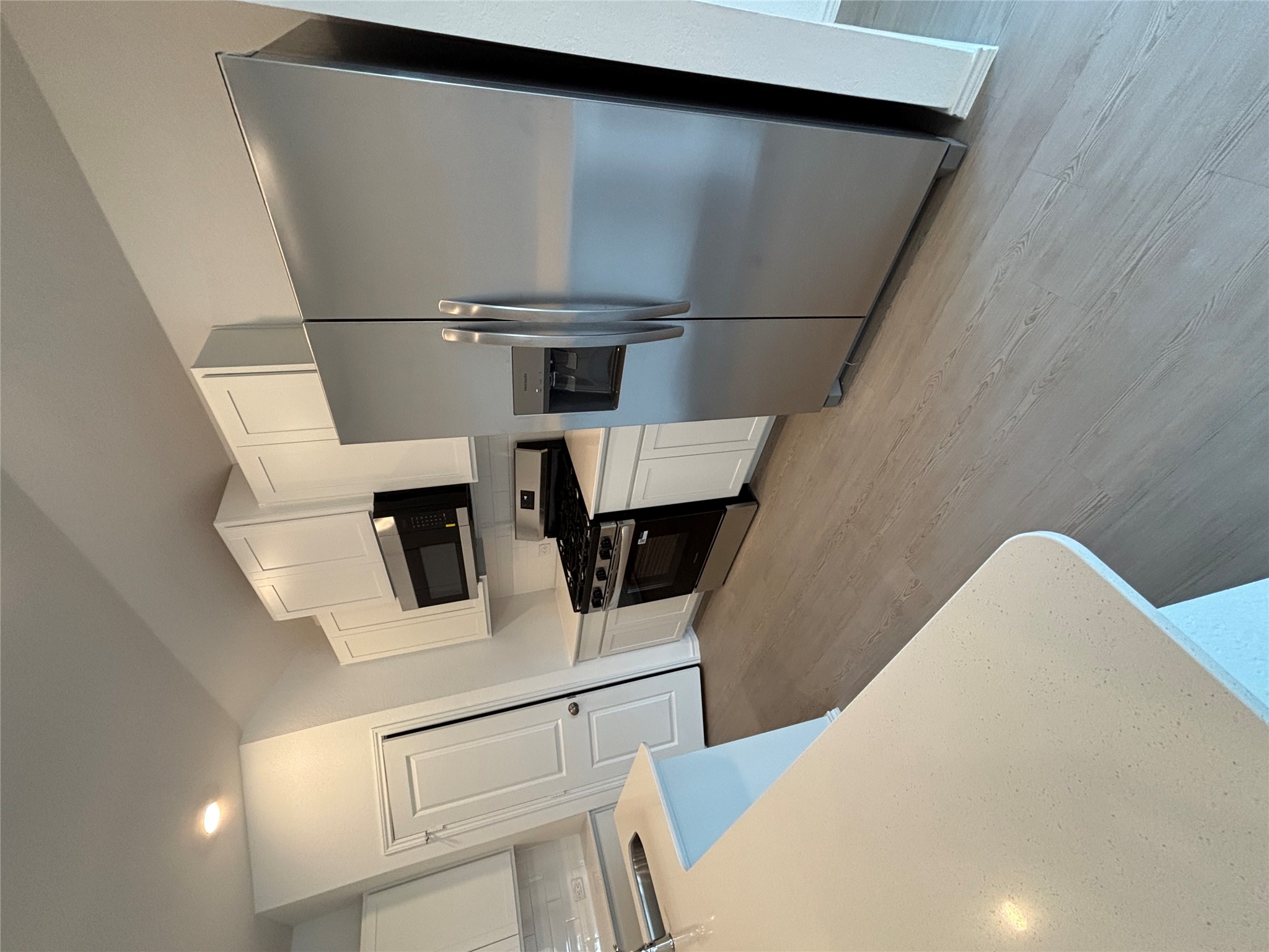 3262 Everett Kyle, TX 78640 - Photo 5 of 24 Kitchen featuring appliances with stainless steel finishes, white cabinetry, light wood-type flooring, light stone counters, and recessed lighting
