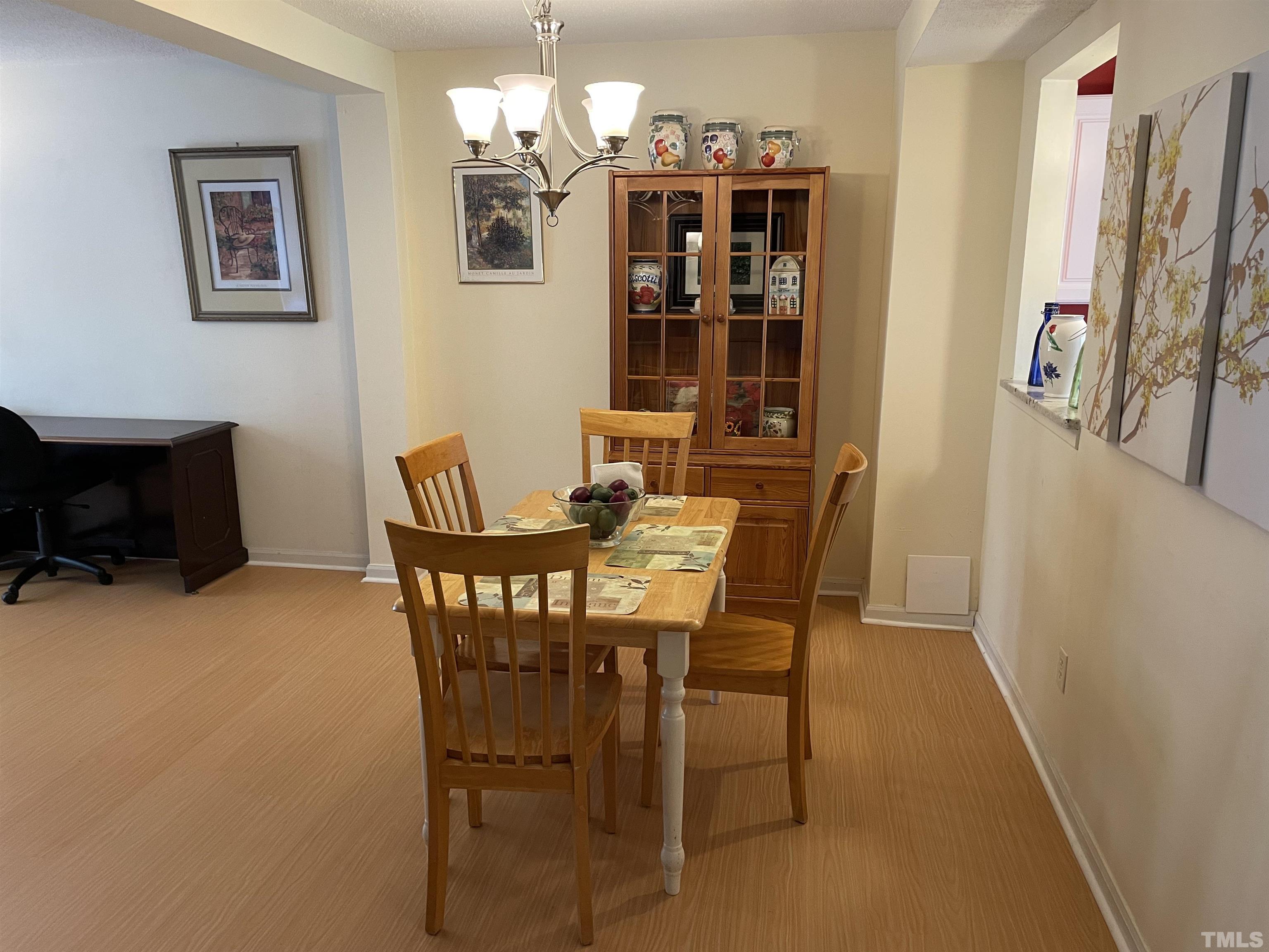 7841 Stephanie Lane Raleigh, NC 27615 - Photo 11 of 37 a view of a dining room with furniture and chandelier