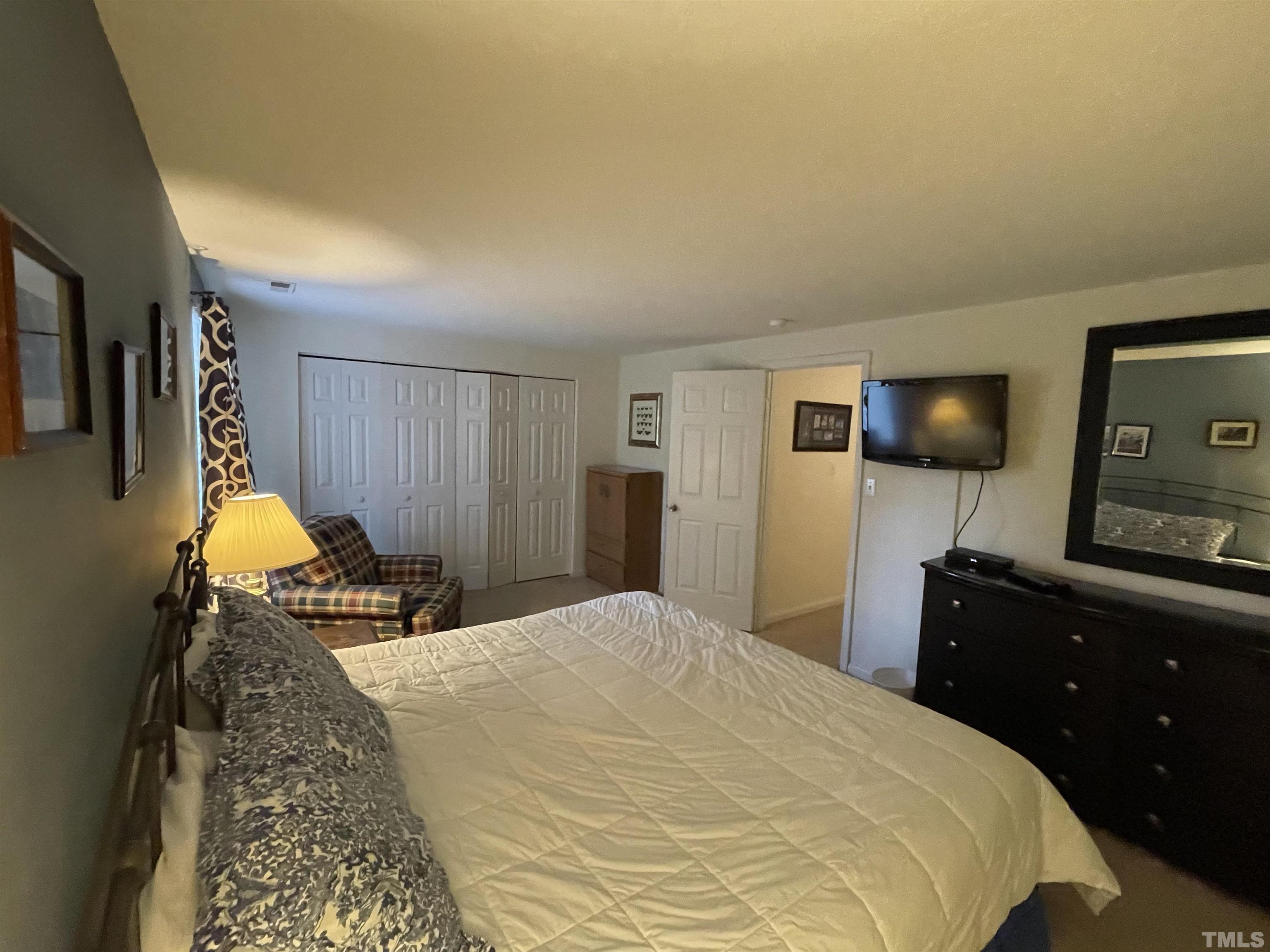 7841 Stephanie Lane Raleigh, NC 27615 - Photo 21 of 37 a bedroom with a bed and a dresser