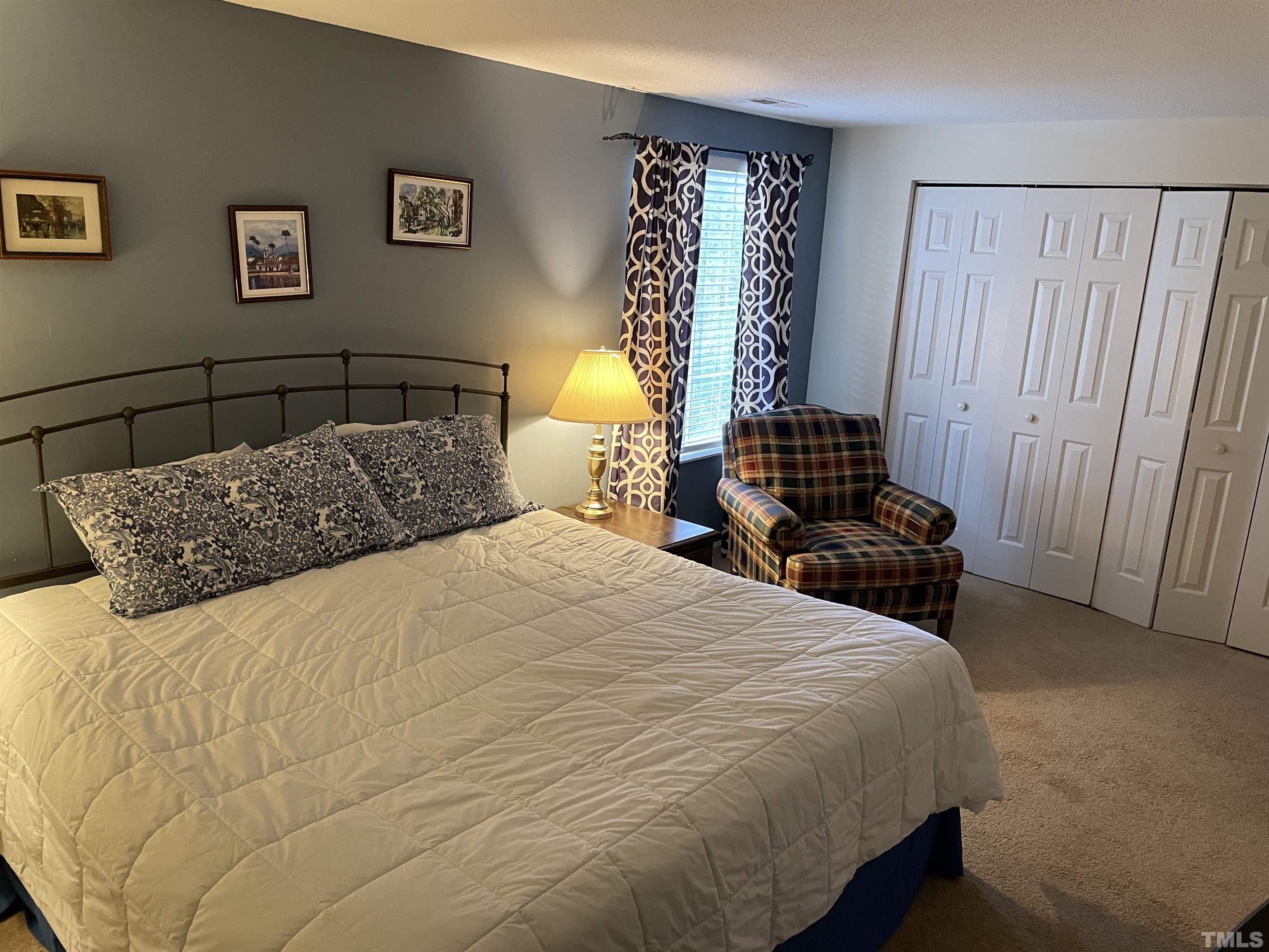 7841 Stephanie Lane Raleigh, NC 27615 - Photo 22 of 37 a bedroom with a bed and wooden floor
