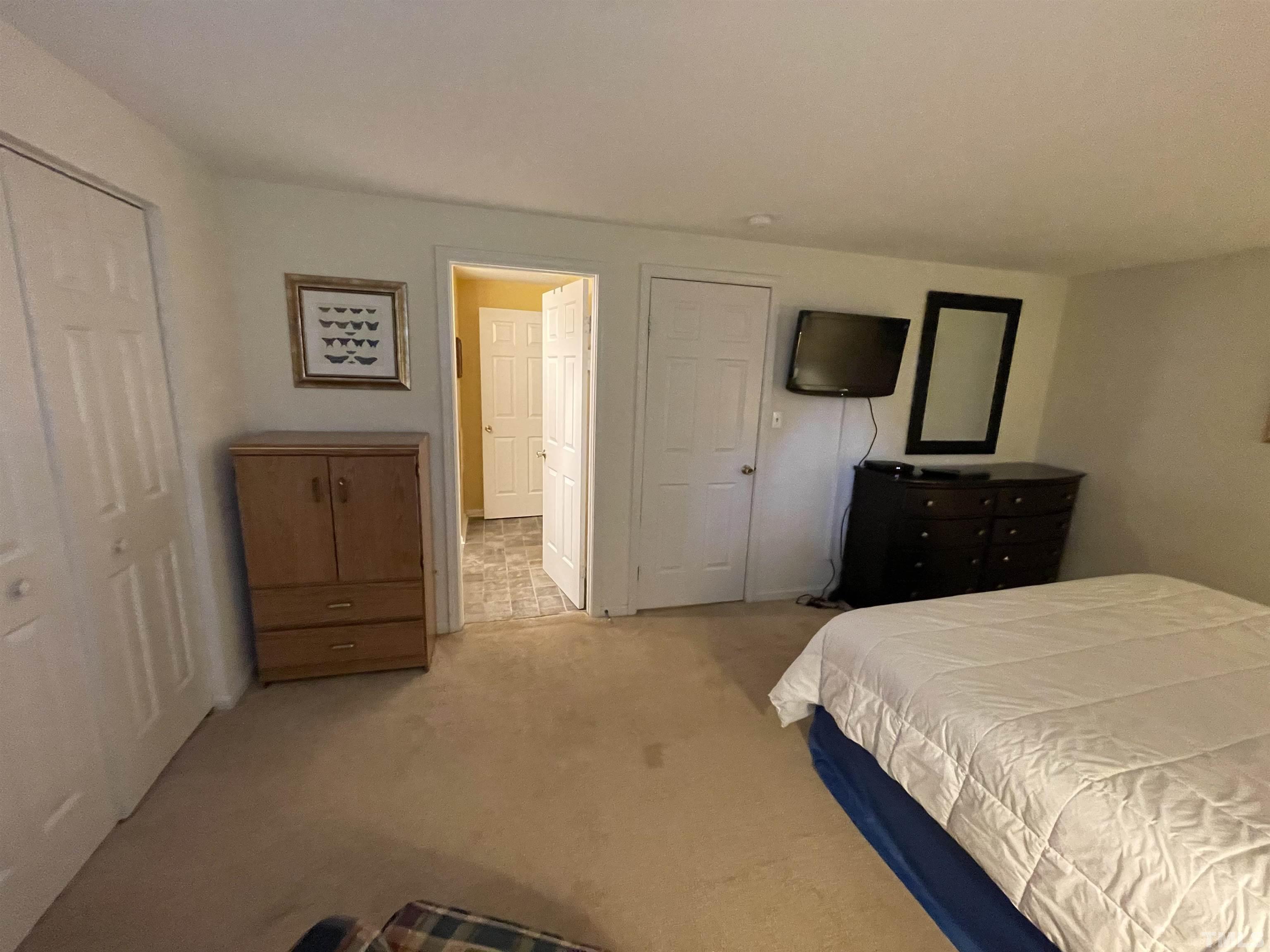7841 Stephanie Lane Raleigh, NC 27615 - Photo 23 of 37 a bedroom with a bed and furniture
