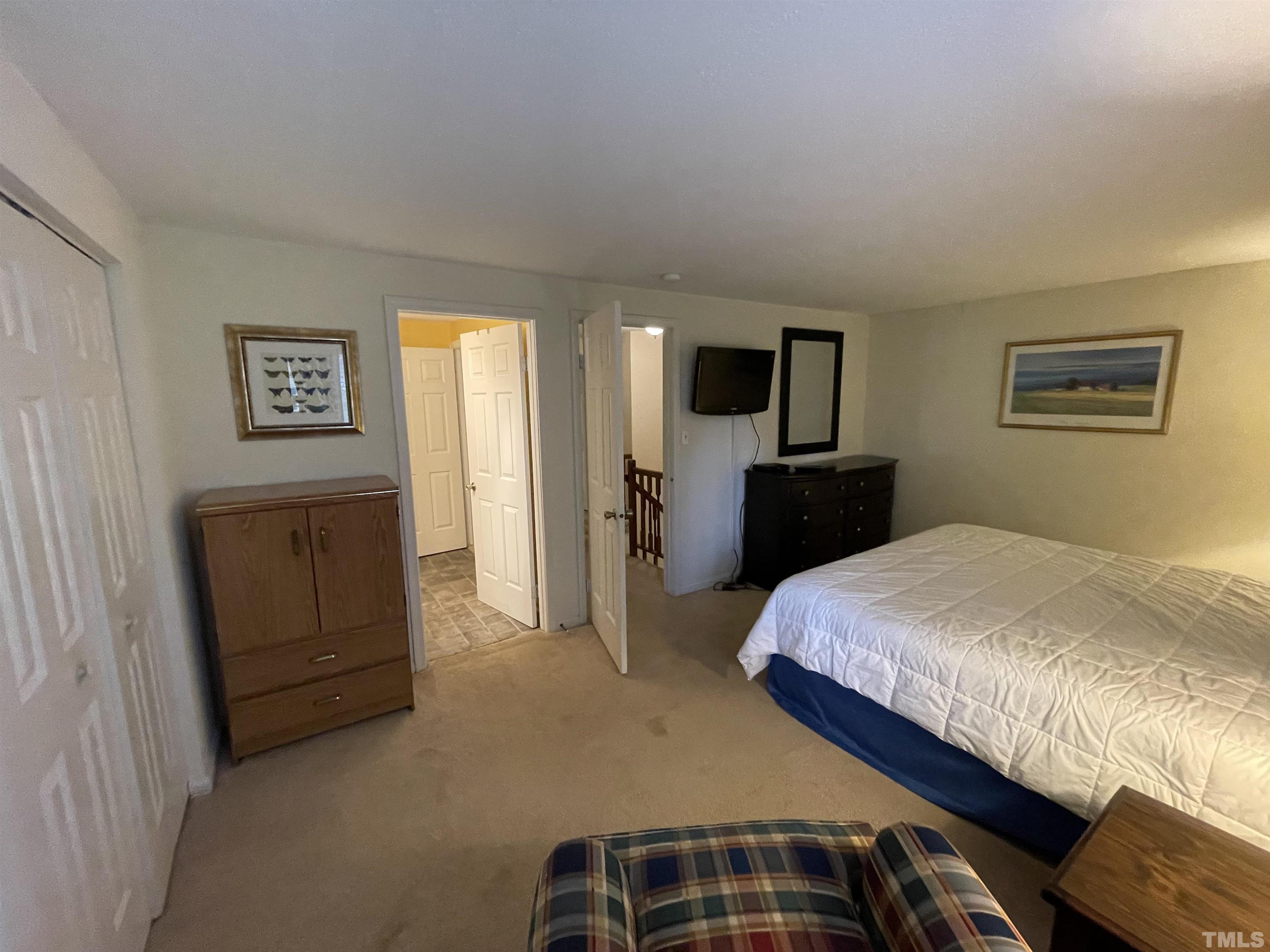 7841 Stephanie Lane Raleigh, NC 27615 - Photo 24 of 37 a bedroom with a bed and dresser