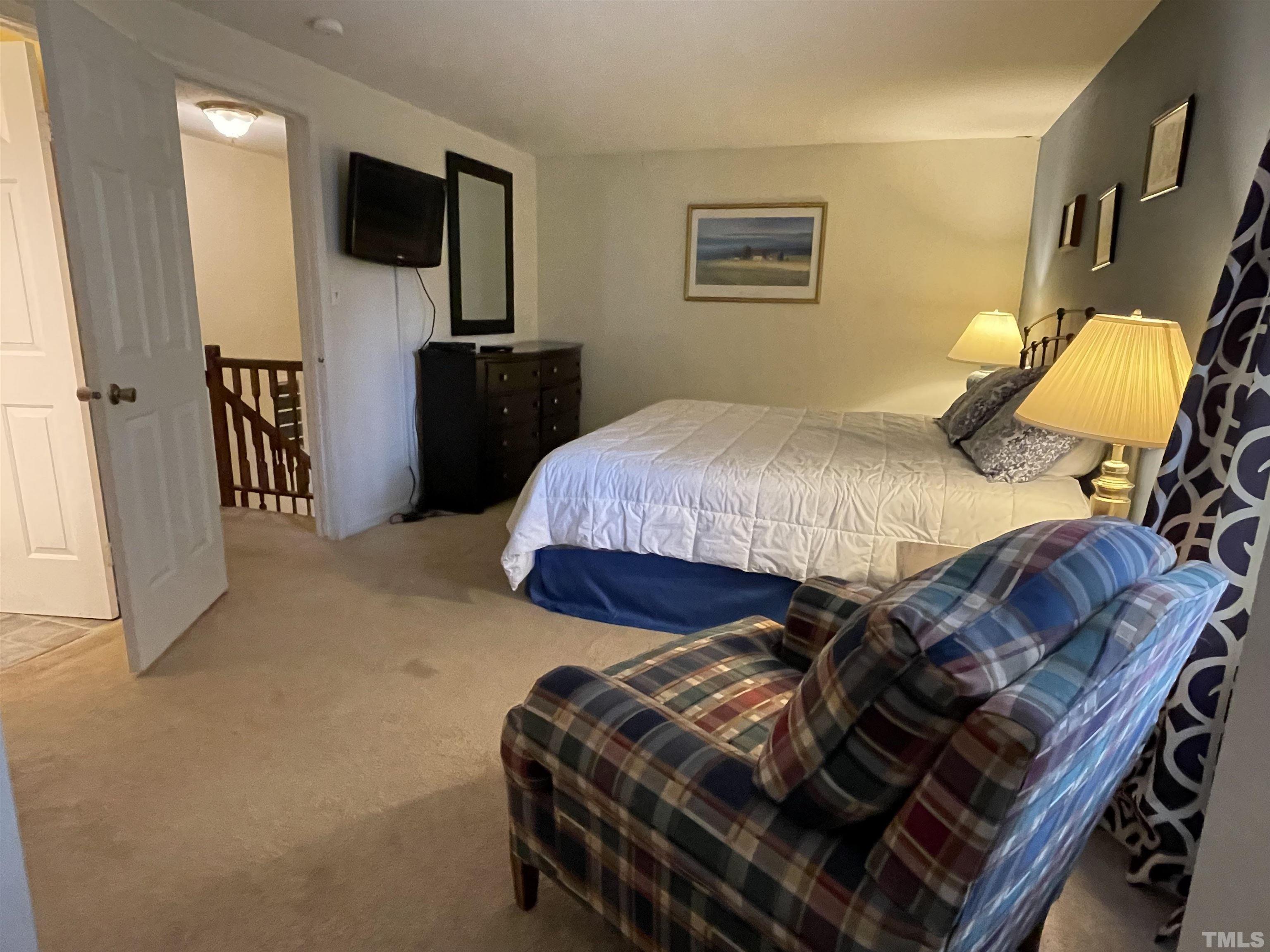 7841 Stephanie Lane Raleigh, NC 27615 - Photo 25 of 37 a bedroom with a bed and a television