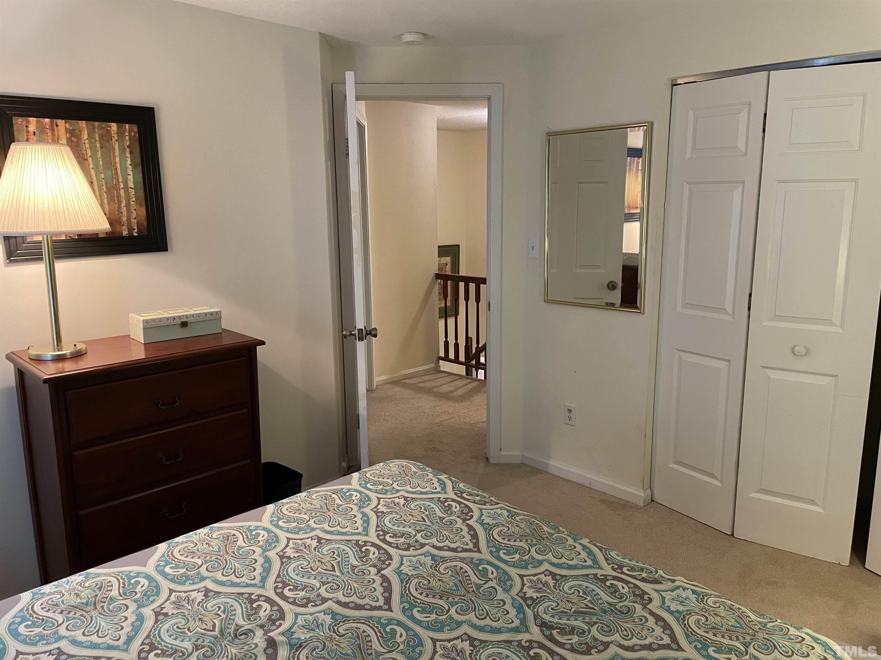 7841 Stephanie Lane Raleigh, NC 27615 - Photo 32 of 37 a bedroom with a bed and a mirror