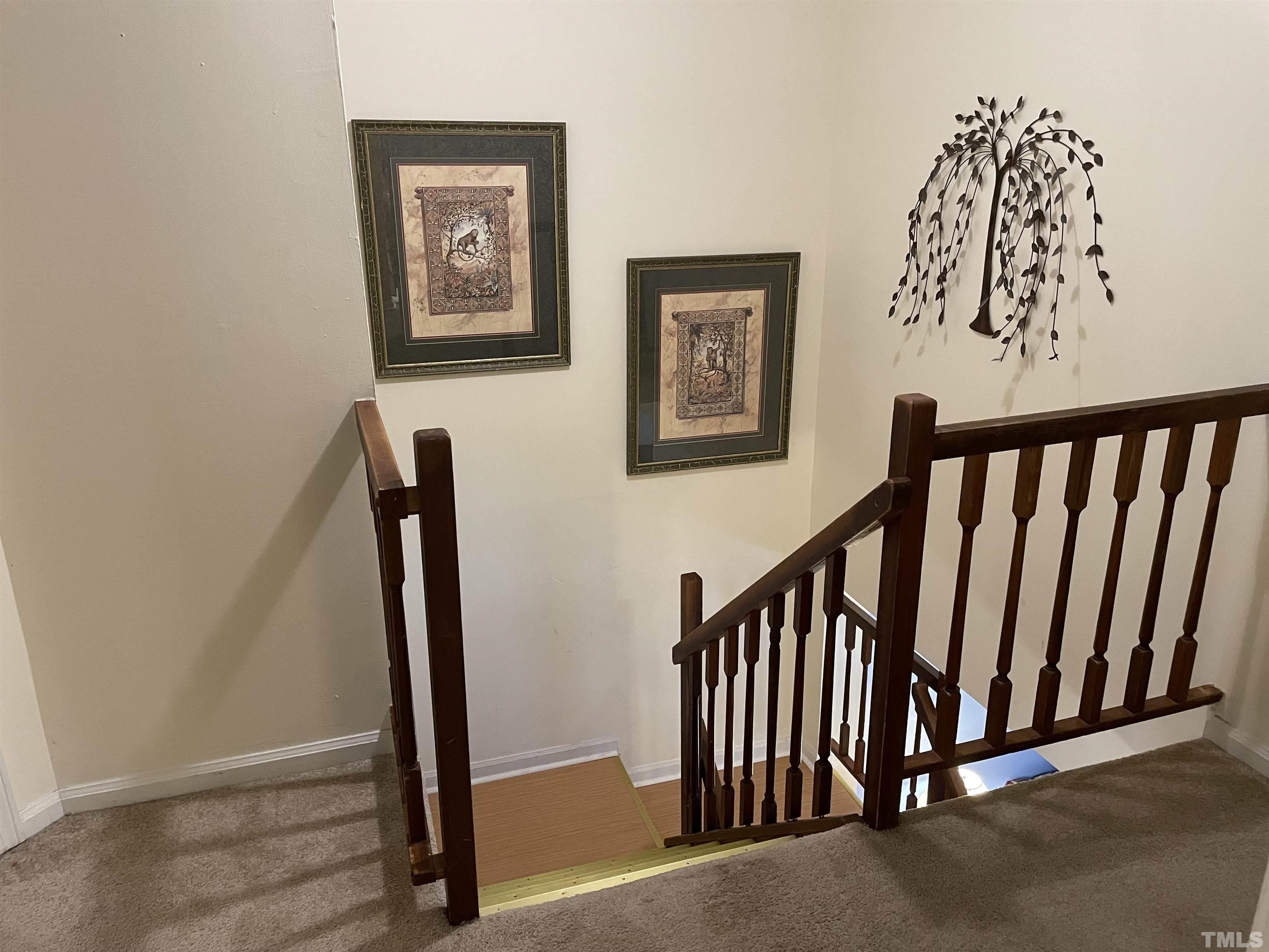 7841 Stephanie Lane Raleigh, NC 27615 - Photo 35 of 37 a view of hallway with stairs and a floor to ceiling window