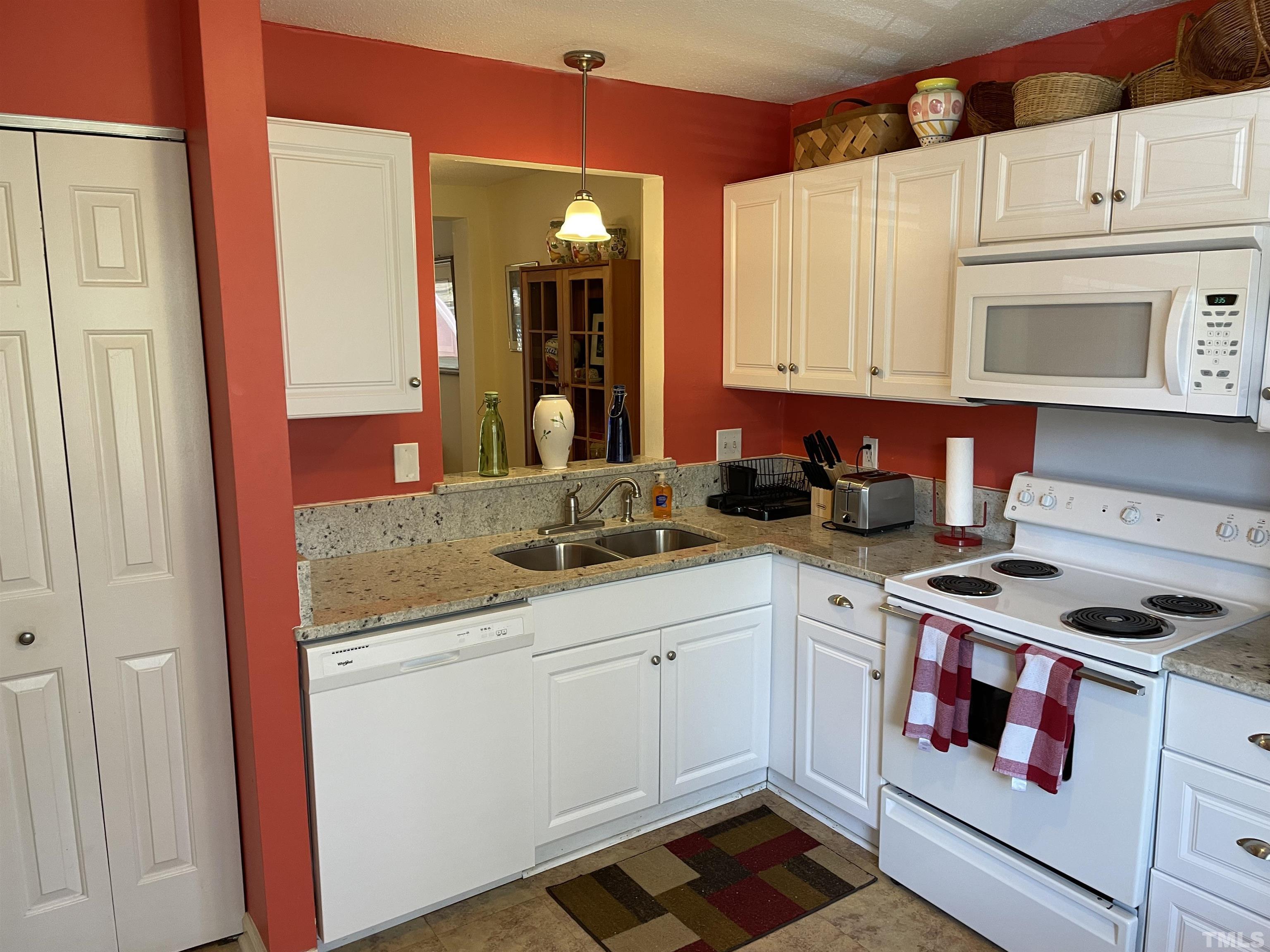7841 Stephanie Lane Raleigh, NC 27615 - Photo 8 of 37 a kitchen with stainless steel appliances granite countertop a stove a sink and a microwave