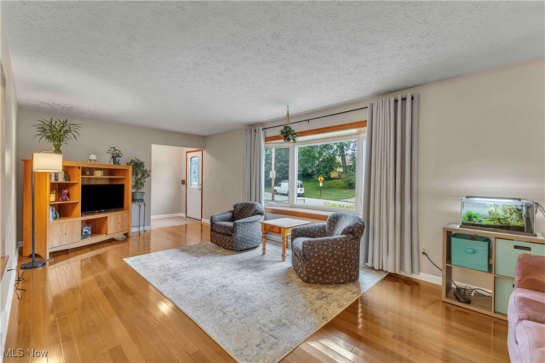 4090 Ridgeview Road Cleveland, OH 44144 - Photo 2 of 40 Living area featuring hardwood / wood-style floors and a textured ceiling