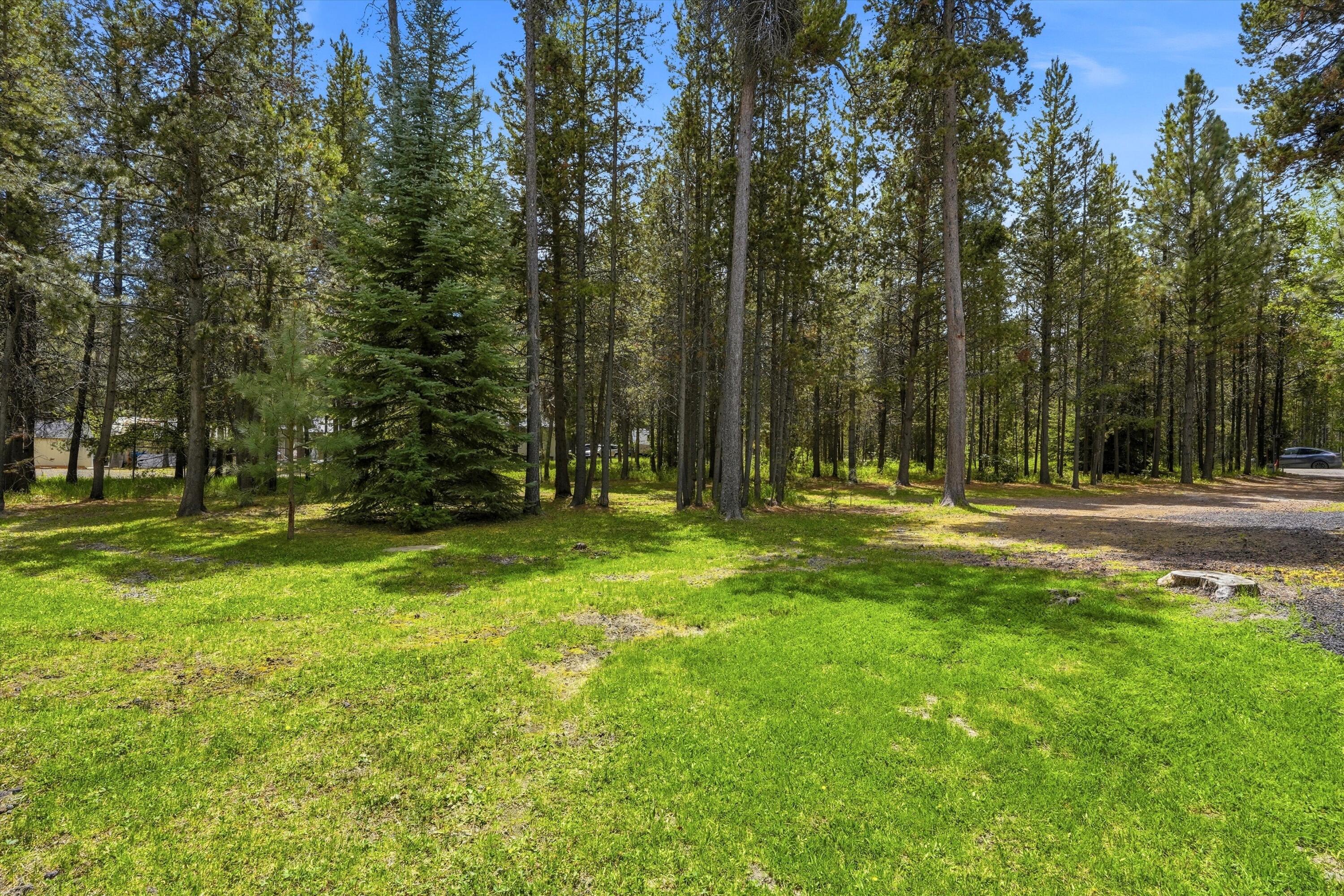 56446 Eclipse Drive Bend, OR 97707 - Photo 11 of 42 a backyard of a house with lots of green space and fountain