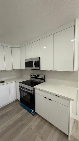 a view of a kitchen with a sink cabinets and a window