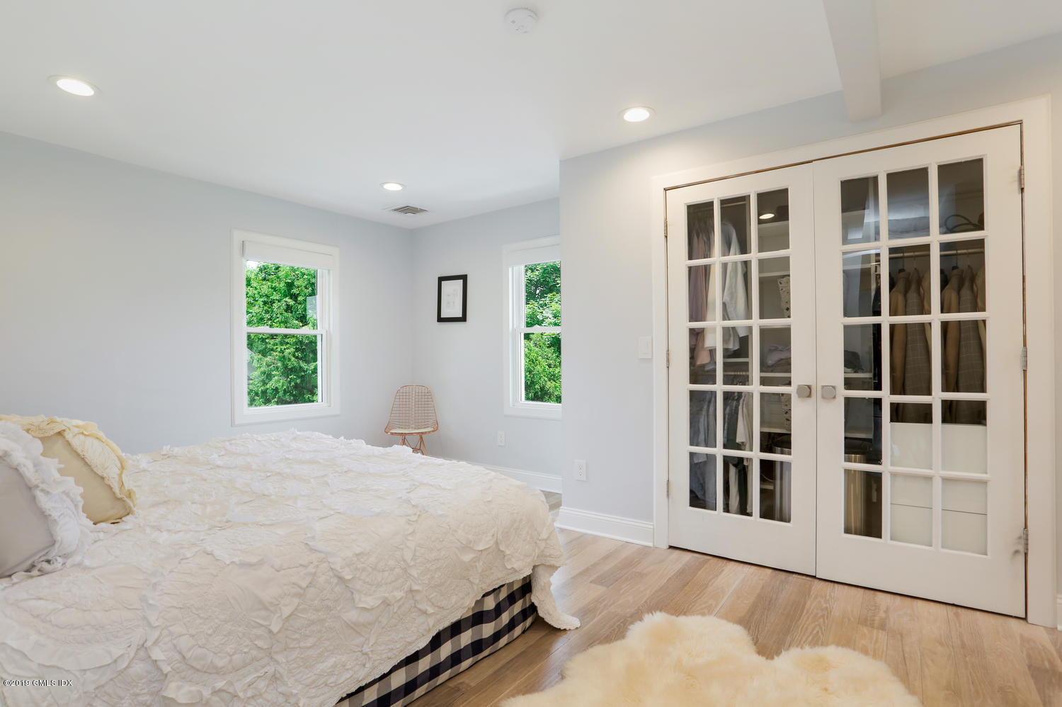 52 Arcadia Road Old Greenwich, CT 06870 - Photo 13 of 28 a bedroom with a bed and a window