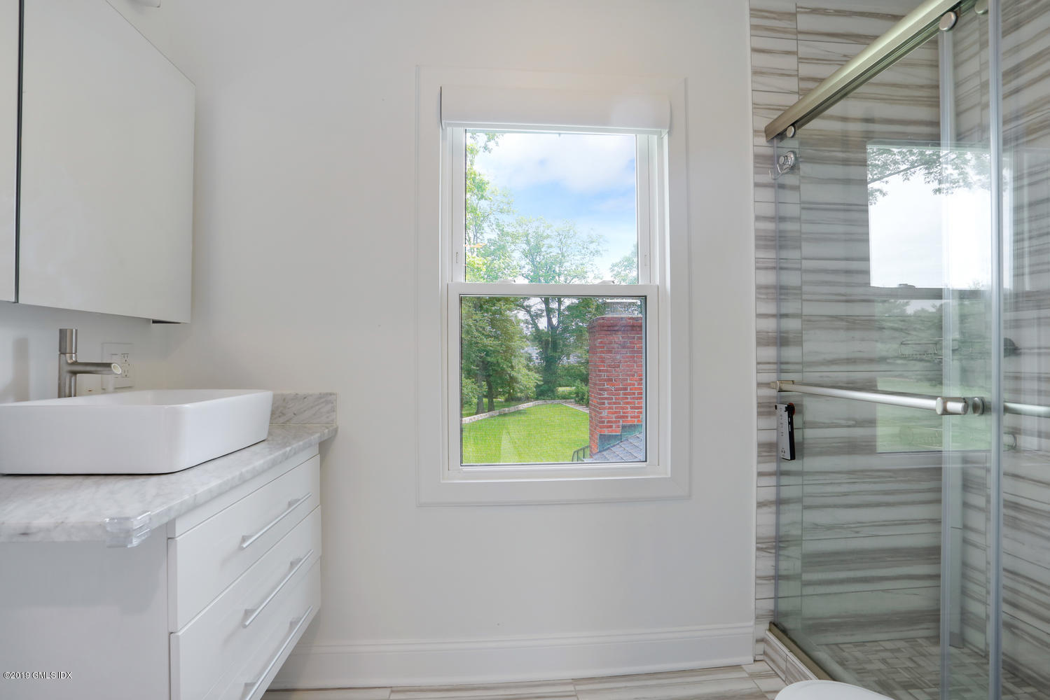 52 Arcadia Road Old Greenwich, CT 06870 - Photo 14 of 28 a bathroom with a granite countertop sink and a window