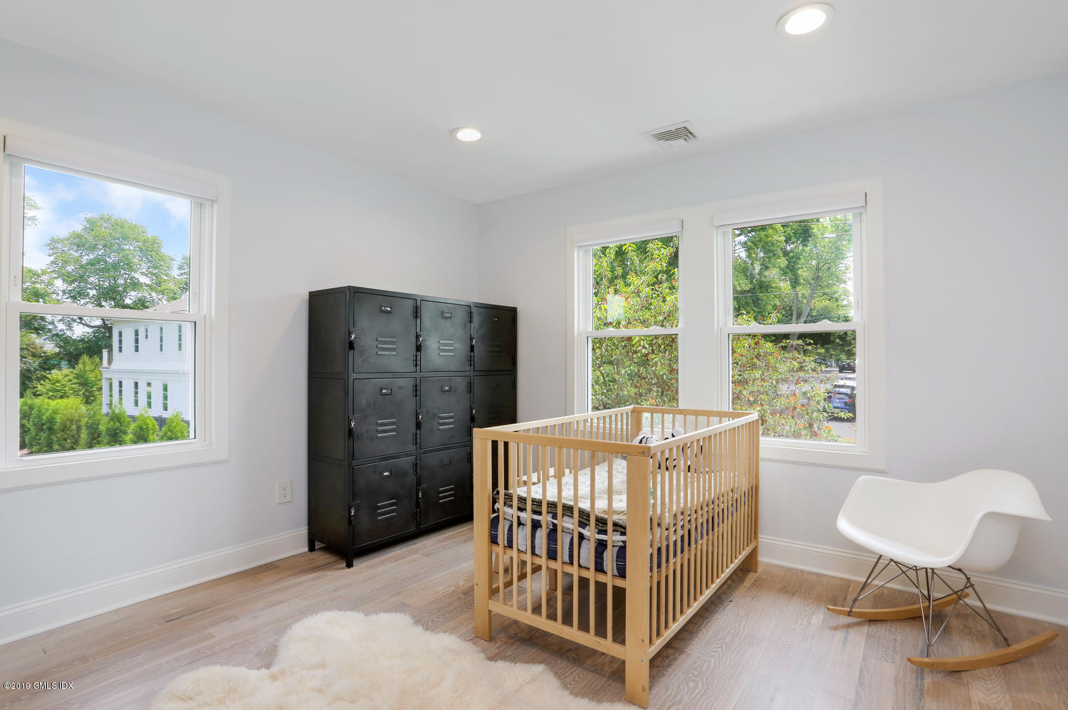 52 Arcadia Road Old Greenwich, CT 06870 - Photo 17 of 28 a bed room with a bed and a window