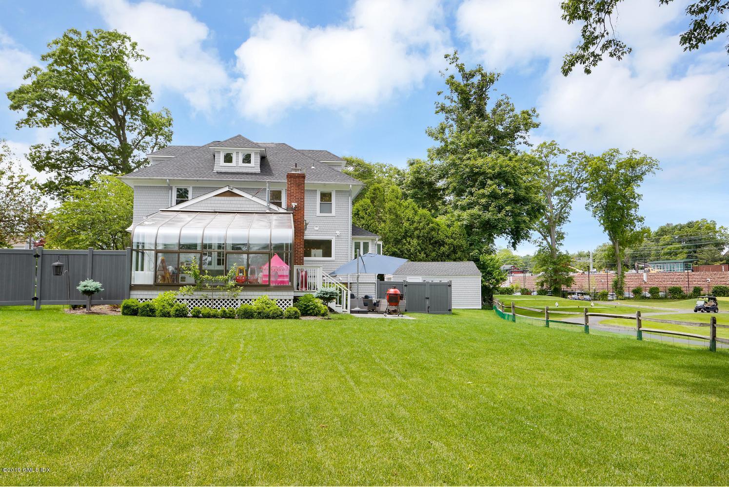 52 Arcadia Road Old Greenwich, CT 06870 - Photo 20 of 28 a view of a house with a big yard and large trees