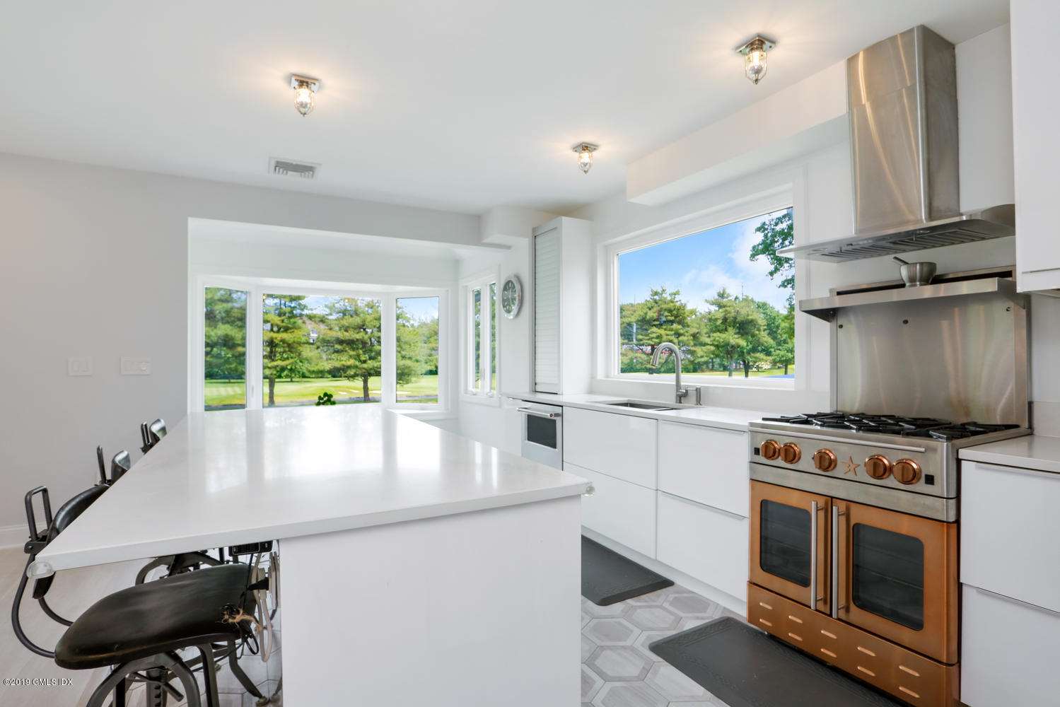 52 Arcadia Road Old Greenwich, CT 06870 - Photo 4 of 28 a kitchen with a stove a sink and a microwave
