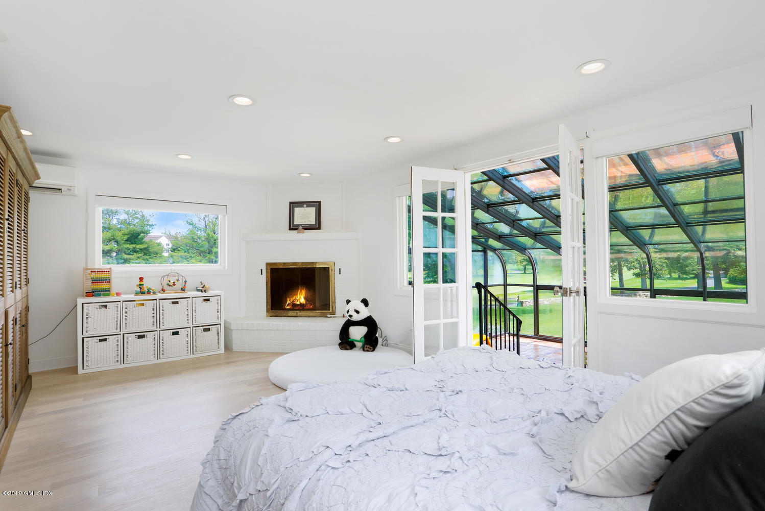 52 Arcadia Road Old Greenwich, CT 06870 - Photo 9 of 28 a bed room with a bed and a large window