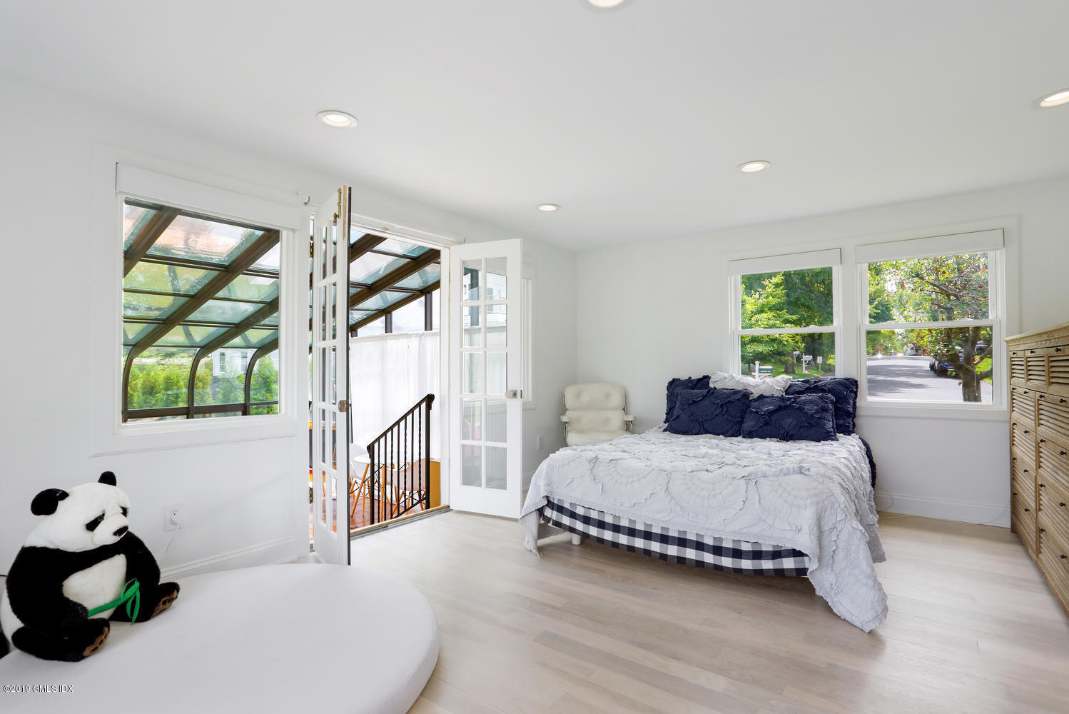 52 Arcadia Road Old Greenwich, CT 06870 - Photo 10 of 28 a bedroom with a bed and a window