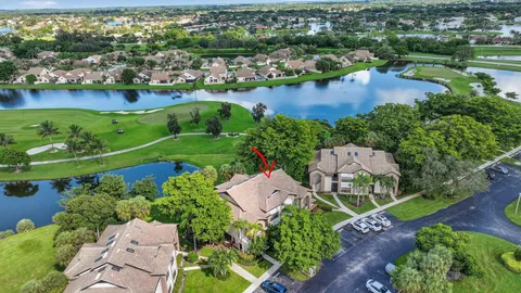 an aerial view of a residential houses with outdoor space and street view