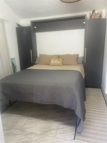 a bedroom with a bed and a mirror