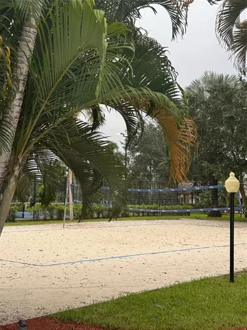 a view of swimming pool with outdoor seating and plants