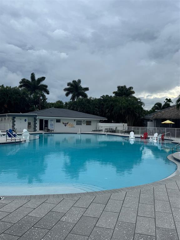 373 Sundial Circle C, Unit 373 Margate, FL 33068 - Photo 17 of 20 a view of swimming pool with outdoor seating and plants