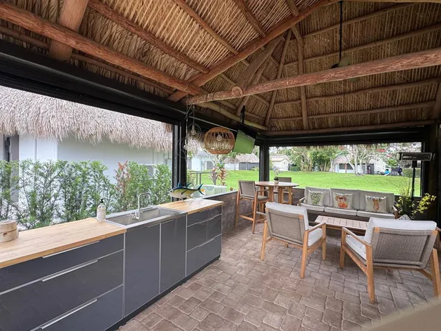 a view of a patio with a table chairs and a backyard