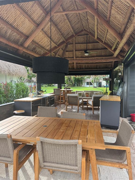 373 Sundial Circle C, Unit 373 Margate, FL 33068 - Photo 5 of 20 a view of a patio with table and chairs barbeque potted plants and large tree