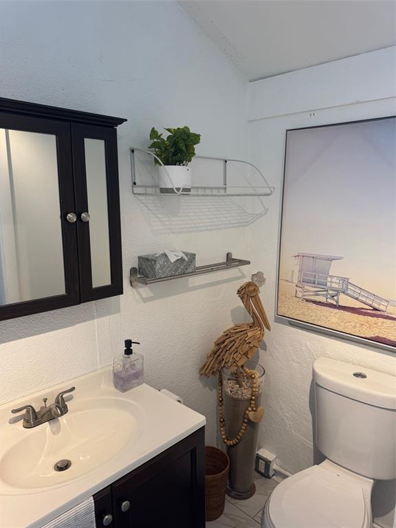 373 Sundial Circle C, Unit 373 Margate, FL 33068 - Photo 10 of 20 a bathroom with a sink a toilet and mirror