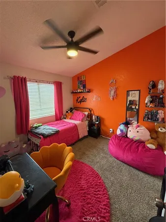 a bedroom with two beds and a chandelier
