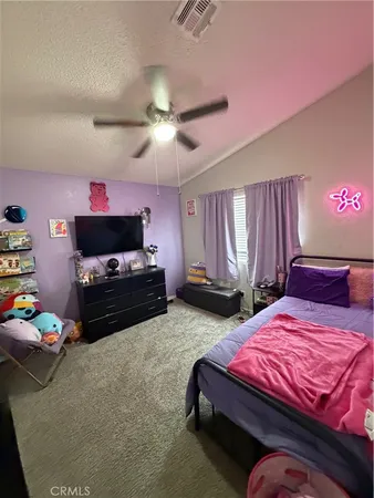 a bedroom with bed and a chandelier