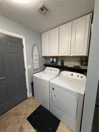 a view of storage and utility room with washer and dryer