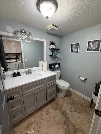 a bathroom with a double vanity sink mirror and toilet
