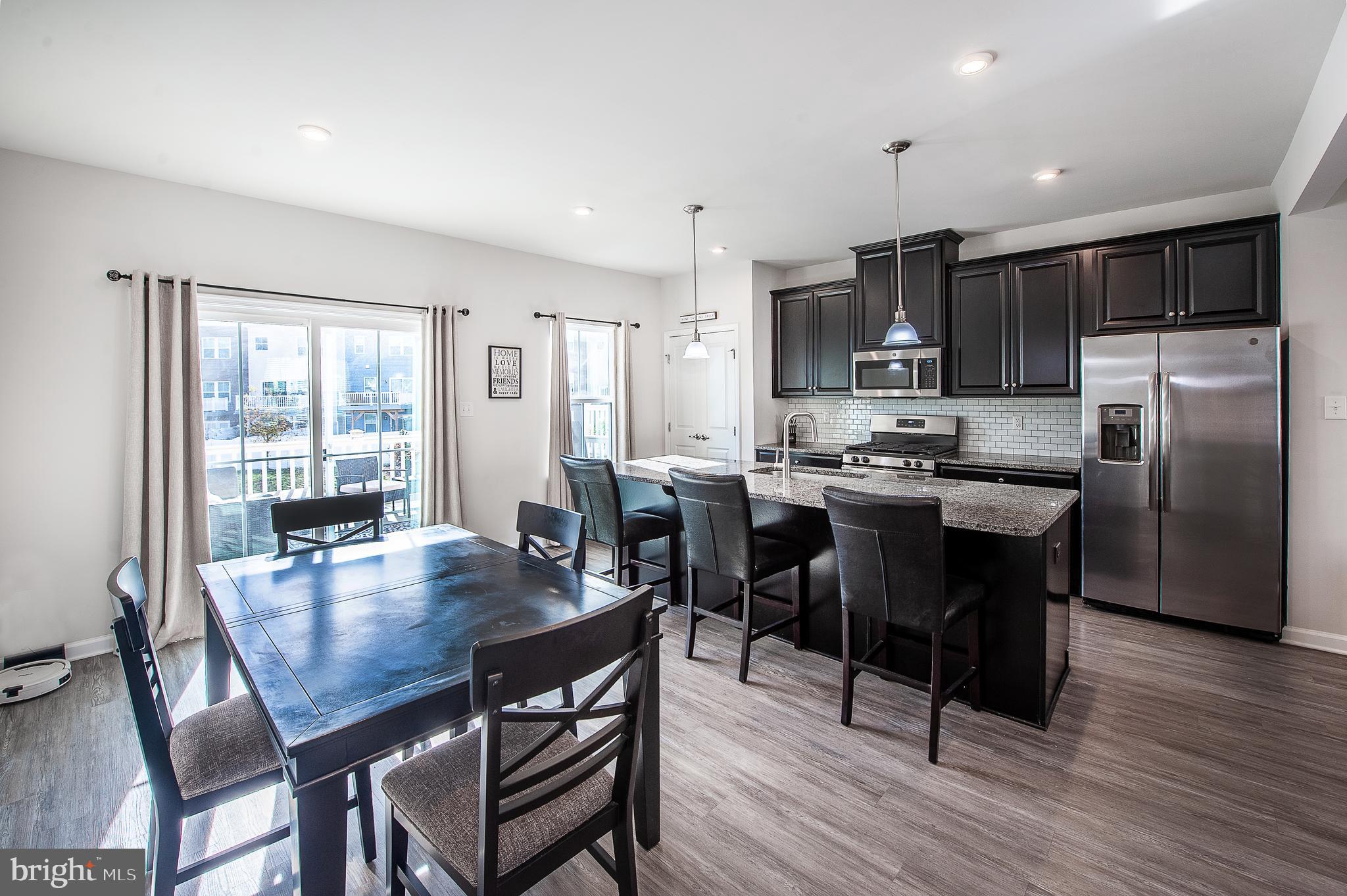 2804 Lamington Court Clarksboro, NJ 08020 - Photo 11 of 24 a kitchen with a dining table chairs and refrigerator