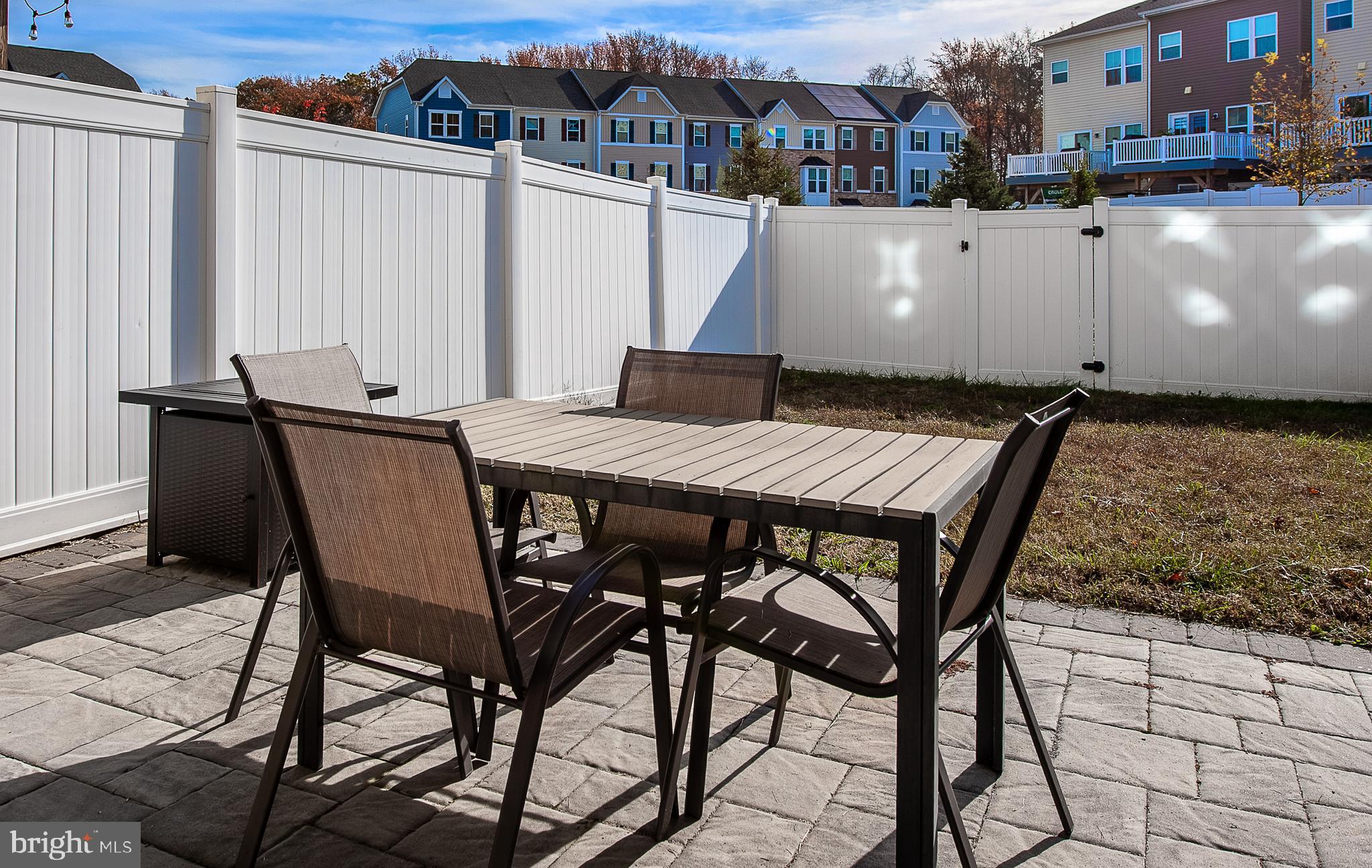 2804 Lamington Court Clarksboro, NJ 08020 - Photo 23 of 24 a view of a patio with table and chairs with wooden floor and fence