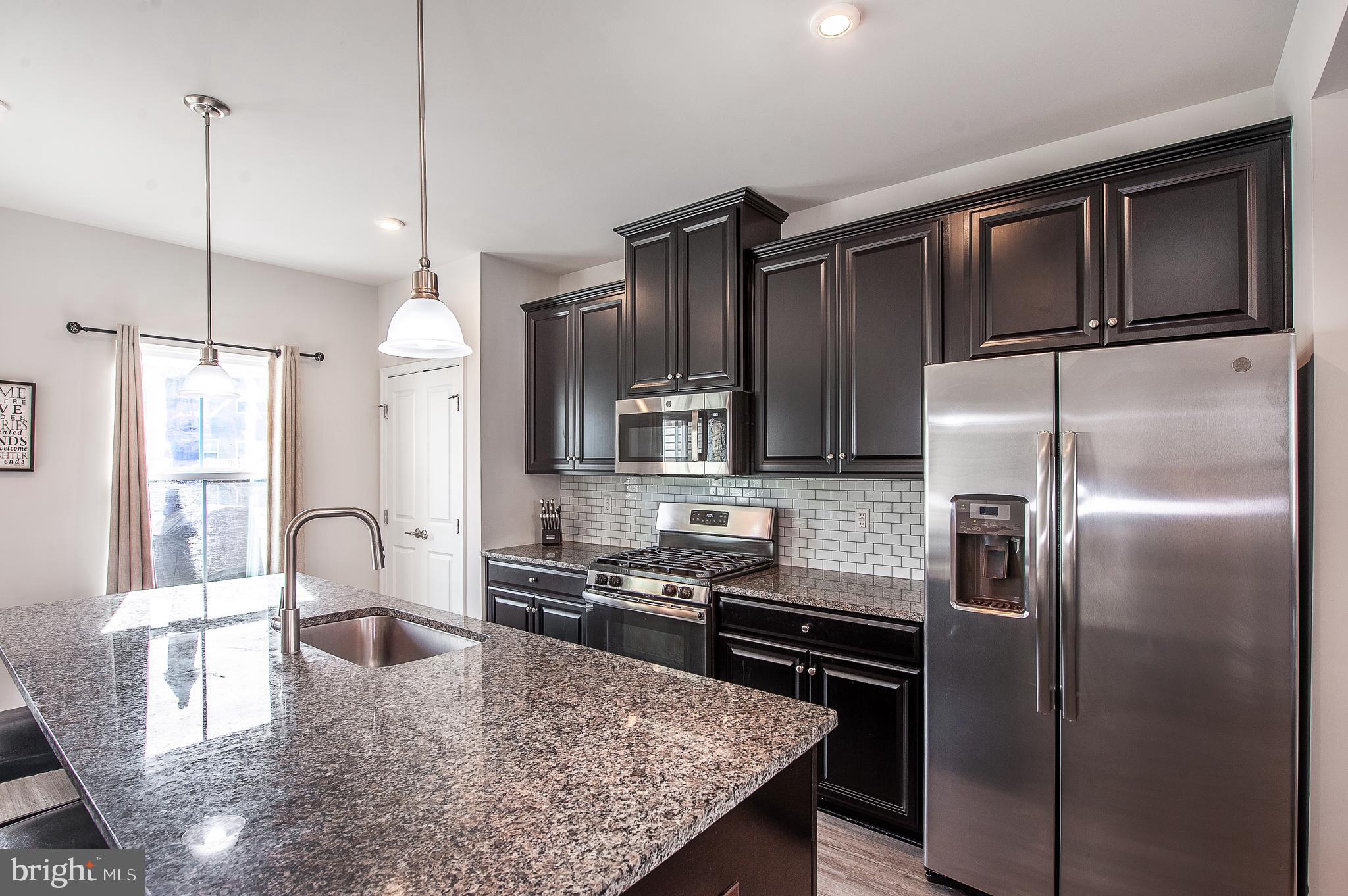 2804 Lamington Court Clarksboro, NJ 08020 - Photo 7 of 24 a kitchen with stainless steel appliances granite countertop a refrigerator a stove and a sink with wooden floor