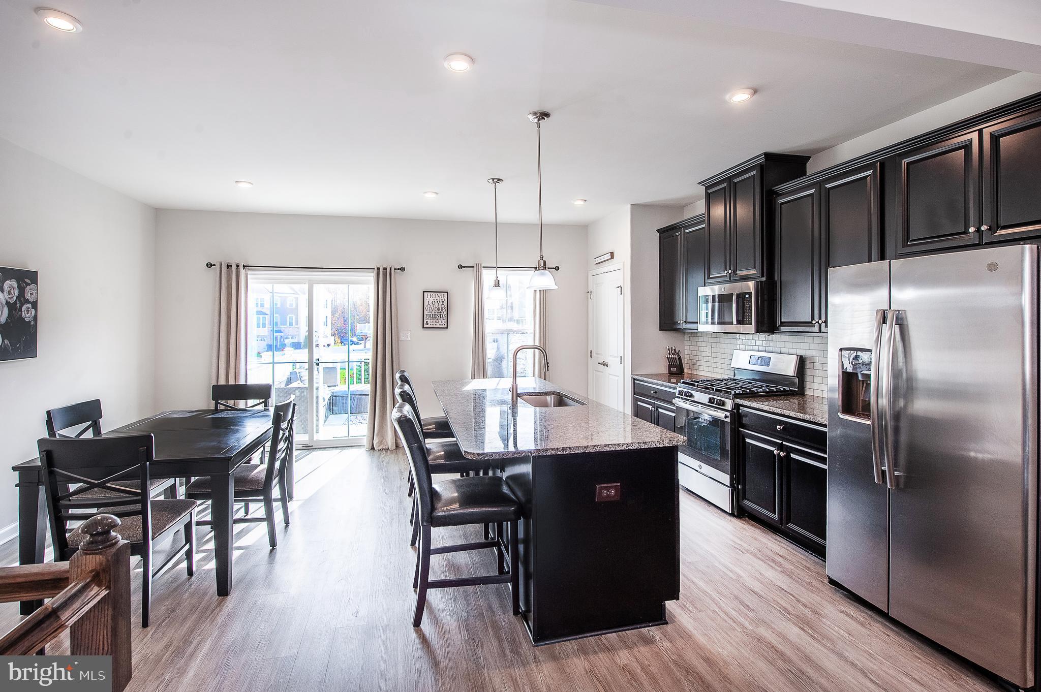 2804 Lamington Court Clarksboro, NJ 08020 - Photo 10 of 24 a kitchen with granite countertop a dining table chairs stainless steel appliances and wooden floor