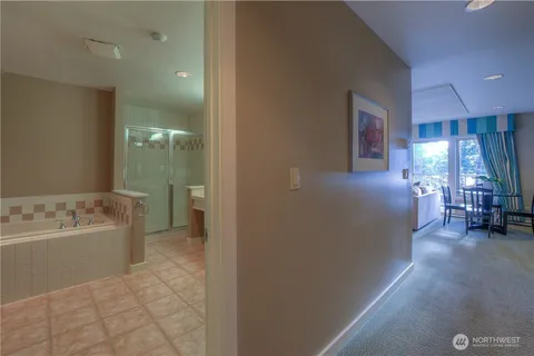 a spacious bathroom with a tub sink and mirror