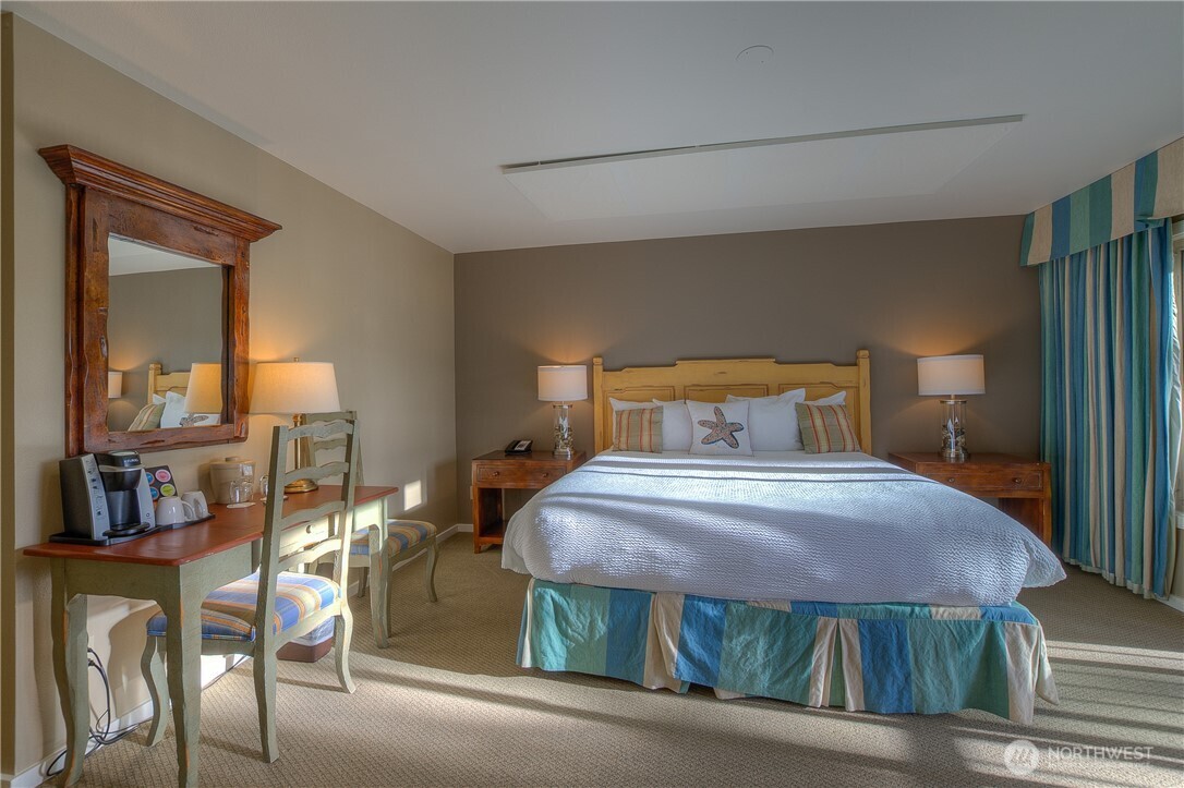 1917 Rosario Road, Unit 2104 Orcas Island, WA 98245 - Photo 16 of 28 a bedroom with a bed and a table