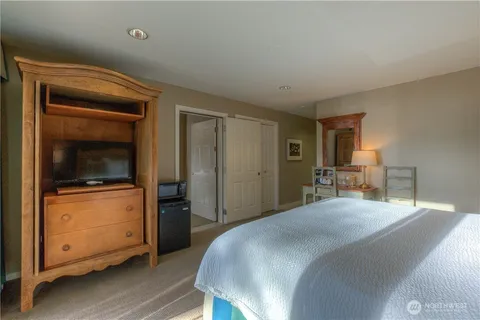 a bedroom with a bed and a television in it