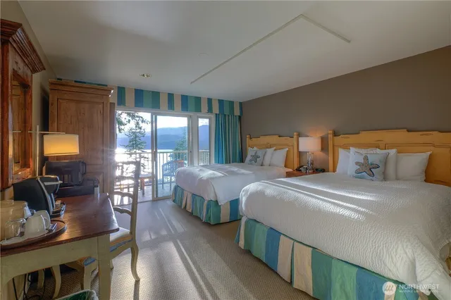 a bedroom with beds and balcony